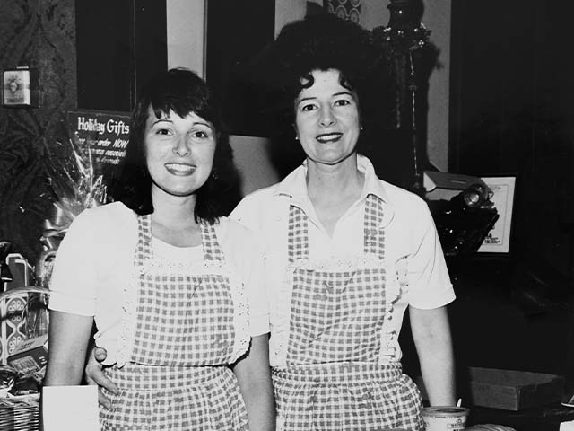 Historical photo of Riboli tasting room workers smiling at camera